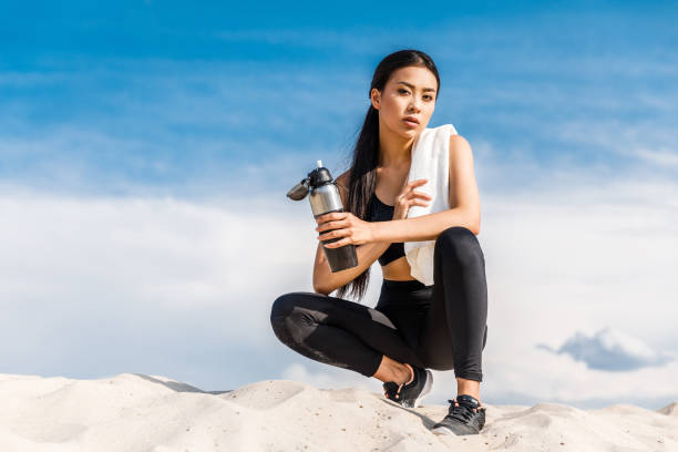 istock sportswoman with sport bottle 841569892