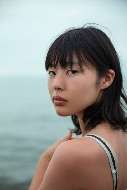 istock Lonely Young Woman By The Sea 841570286