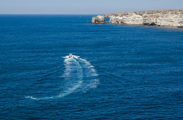 istock The boat in the blue sea 841574306