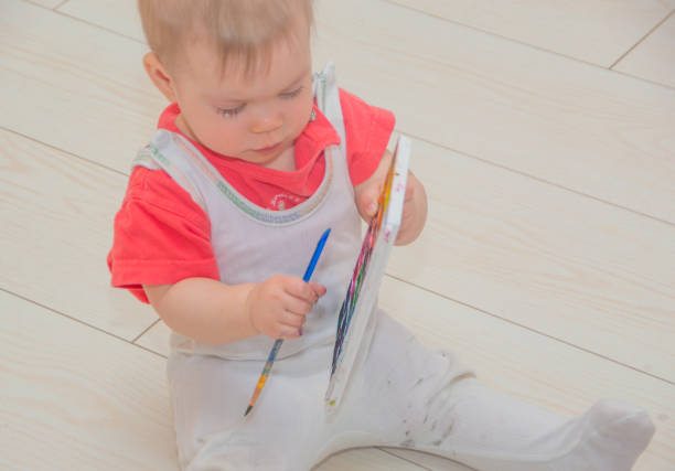 istock watercolor and a brush in hands baby 841577986