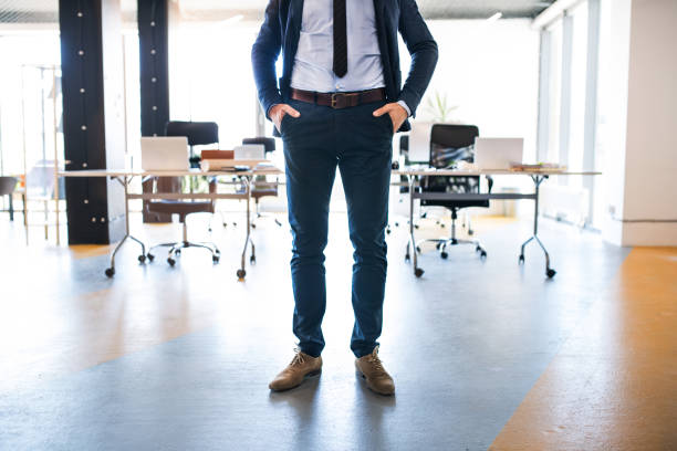 istock Unrecognizable businessman standing in his office, hands in pockets. 841583754