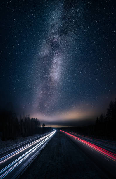 Scenic night landscape with milky way and highway Scenic night landscape with milky way and highway moment of silence stock pictures, royalty-free photos & images