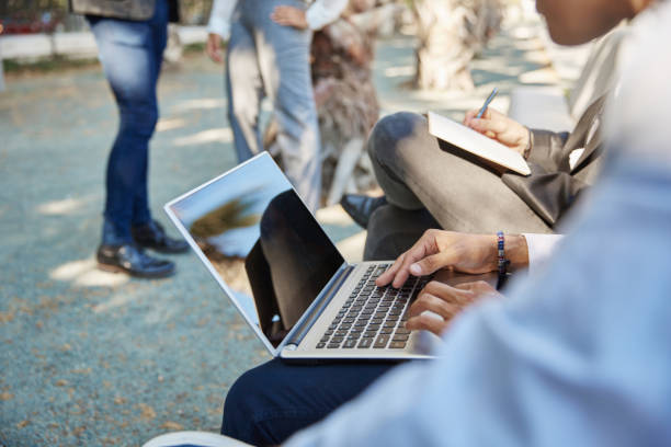 istock Coworkers working together on laptop outside 841584496