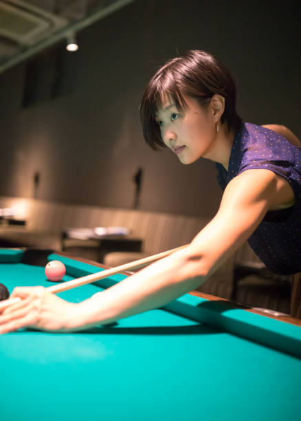 istock Young woman playing billiards 841587898