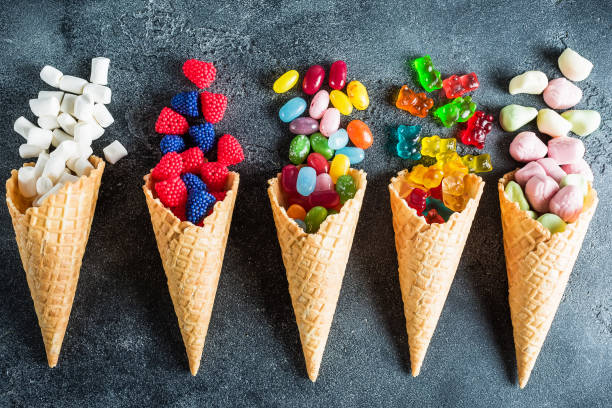 istock Colorful candy in waffle cones. Summer concept. Flat lay, top view 841588766