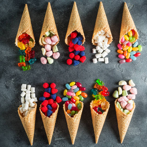 istock Assorted candy in waffle cones. Summer concept. Flat lay, top view 841588774