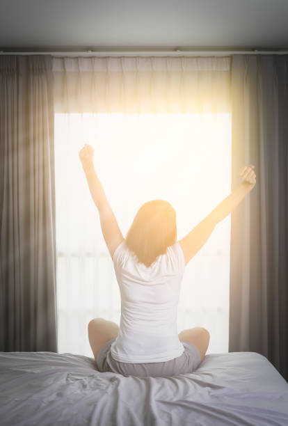 istock Asian Woman stretching in bed after wake up 841592400