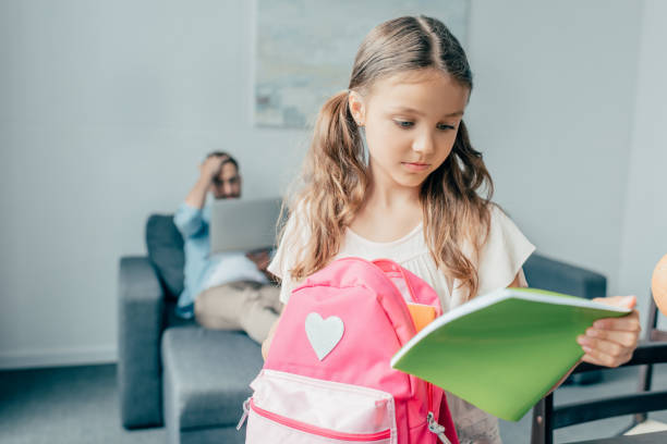 istock beautiful girl preparing backpack for school 841596662
