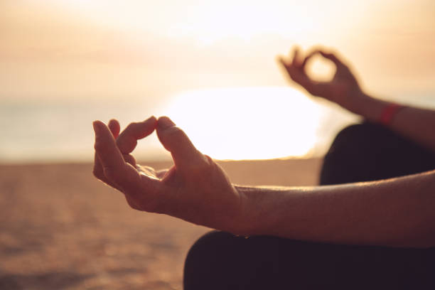 istock Hands of mature woman practicing yoga 841597102