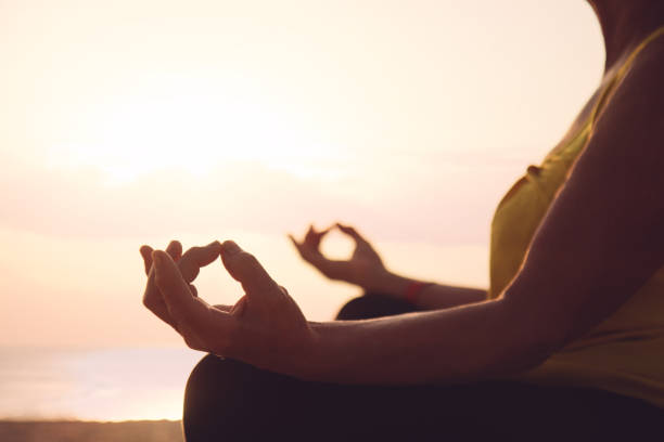 istock Hands of mature woman practicing yoga 841597114