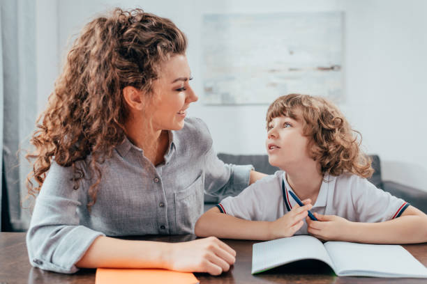 istock beautiful young mother and son doing homework together 841597368