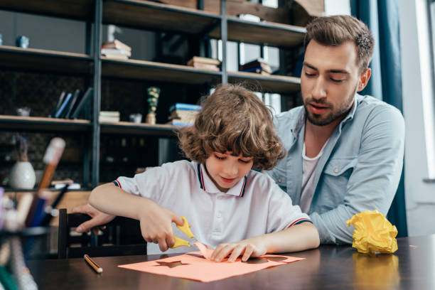 istock father and adorable little son doing carving for homework 841610466