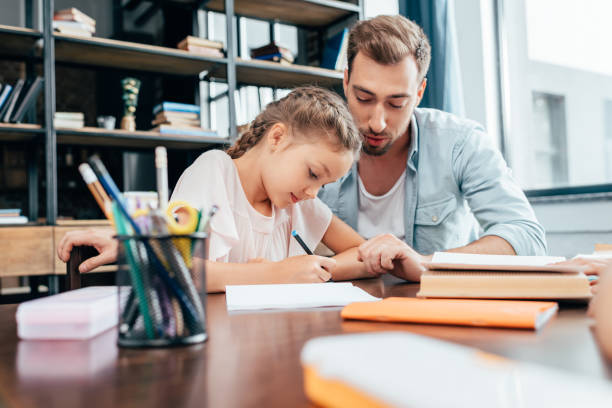 istock young father doing homework with little daughter 841621498