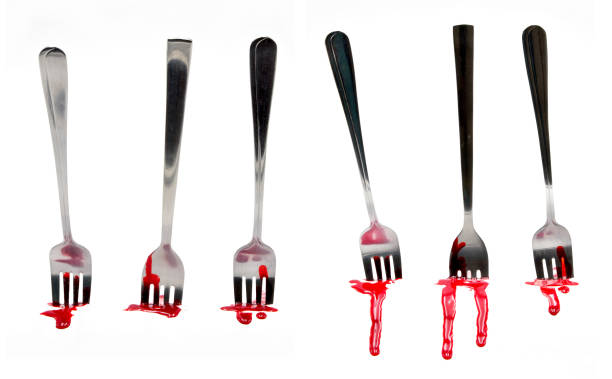 fork with blood on white background stock photo