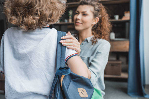 istock beautiful young mother preparing her little son for school 841627672