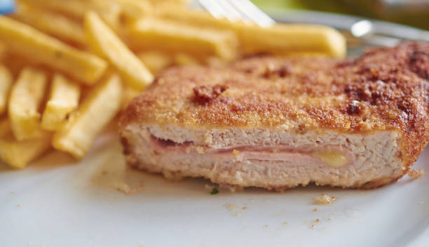 cut schnitzel stuffed with ham and cheese, close up. - hot couture imagens e fotografias de stock