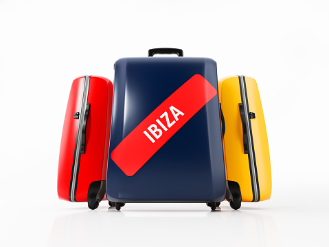 Red, dark blue and yellow colored luggages with red  Ibiza sticker. Isolated on white background.  Clipping path is included. Horizontal composition with copy space. Airline and travel Concept