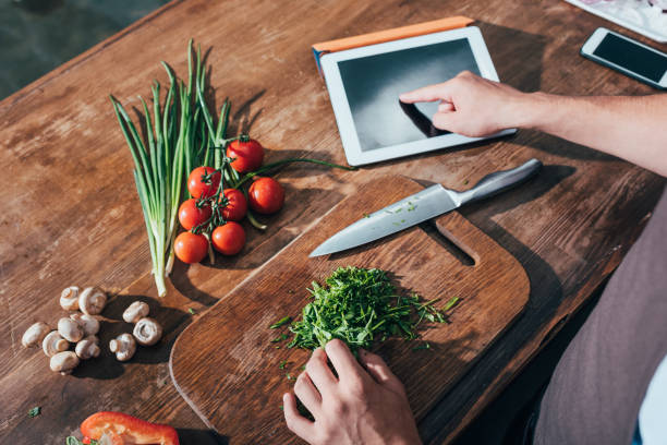 istock cropped shot of man cooking with tablet 841641894