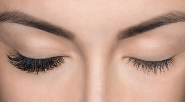 Eyelash removal procedure close up. Beautiful Woman with long lashes in a beauty salon. Eyelash removal procedure close up. Beautiful Woman with long lashes in a beauty salon. Eyelash extension. mink fur stock pictures, royalty-free photos & images