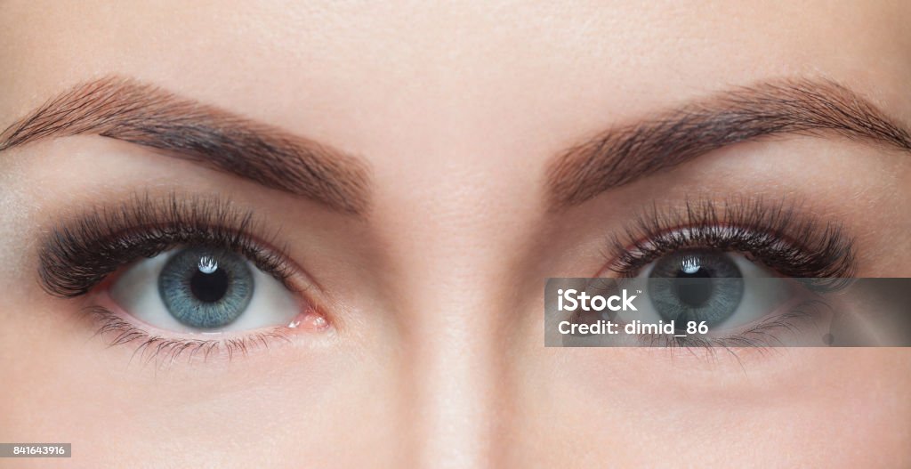 Eyelash removal procedure close up. Beautiful Woman with long lashes in a beauty salon Eyelash removal procedure close up. Beautiful Woman with long lashes in a beauty salon. Look at the camera. Eyebrow Stock Photo