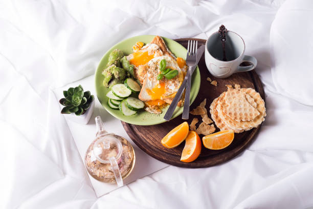 istock Fried eggs with toasts and tea in bed 841649476