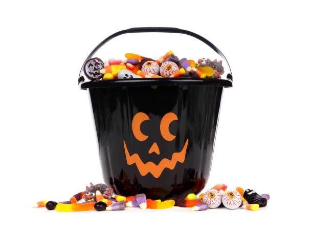 istock Black Jack o Lantern candy collector with candy pile over white 841654066