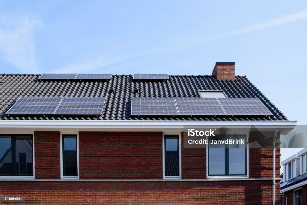 Solar panels on a new house Solar panels on the roof of a new house House Stock Photo