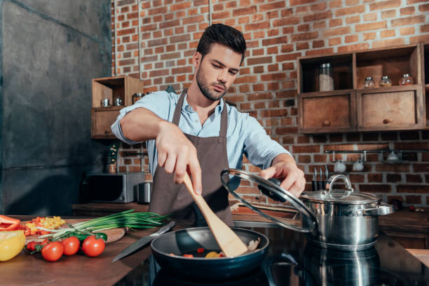 istock pensive handsome man with apron cooking 841657220