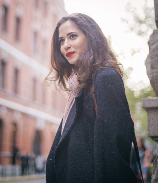 istock Smiling woman standing on the street 841659614
