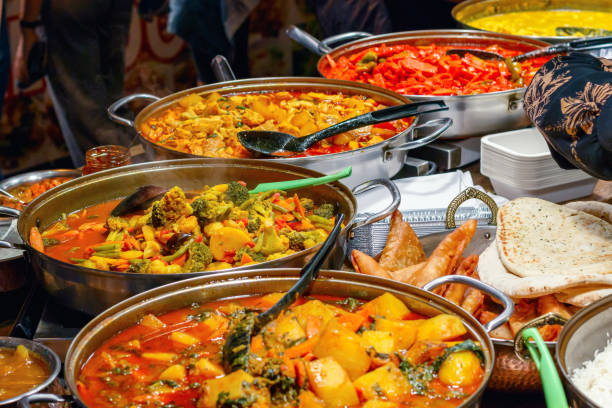 Curries on display at Camden Market in London Variety of cooked curries on display at Camden Market in London camden lock stock pictures, royalty-free photos & images