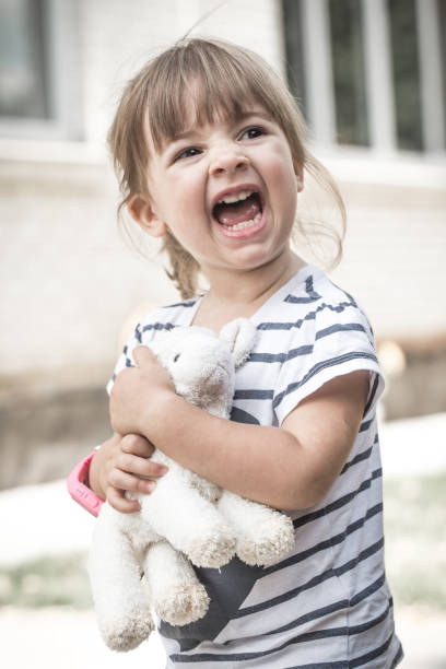 istock little girl with toy lamb 841660084