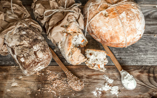 istock fresh bread and wooden spoon on old wooden background 841663174
