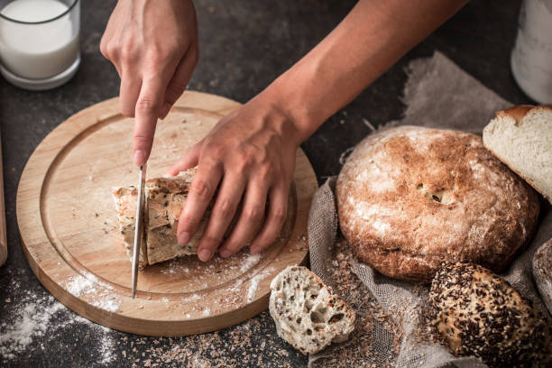 istock fresh bread in hands closeup on old wooden background 841663186