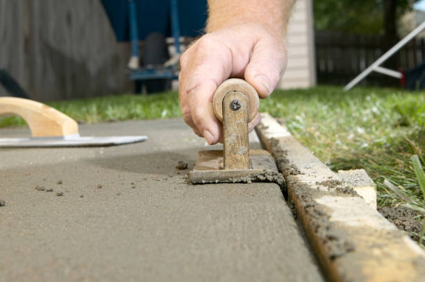 Close up of man finishing cement with edging tool stock photo
