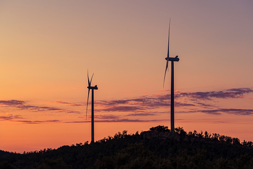 wind turbines at sunset on a hill in Tuscany, Italy