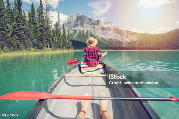 Pov Of Couple Paddling Red Canoe On Turquoise Lake Stock Photo - Download Image Now - Canada, Travel, Personal Perspective
