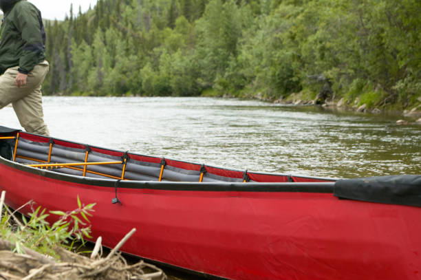 istock Beached, red inflatable canoe on river in Alaska 841673954