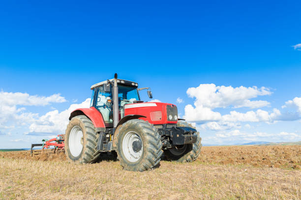 istock agricultural tractor in the foreground with blue sky background 841674076