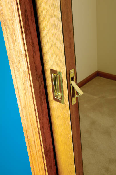 Open wooden pocket door slid back into the wall stock photo