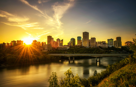 Sunset above Edmonton downtown, James Macdonald Bridge and the Saskatchewan River, Alberta, Canada. Long exposure.