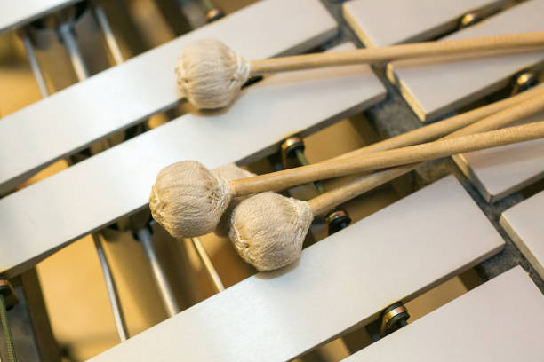 xylophone, musical chromatic instruments concept - closeup on wooden bars with mallets, glockenspiel, marimba, balafon, semantron, pixiphone, education and orchestra concert usage, top view