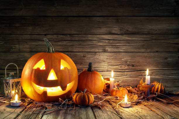 istock Halloween Pumpkins And Candles On Wooden 841691704