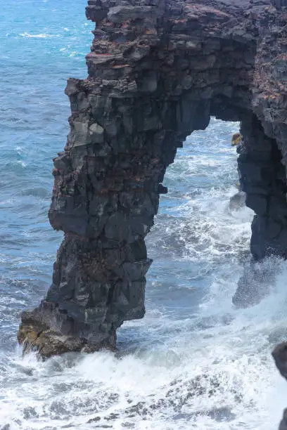 Holei Sea Arch in Hawaii volcanoe national park looking out over lava flow into ocean