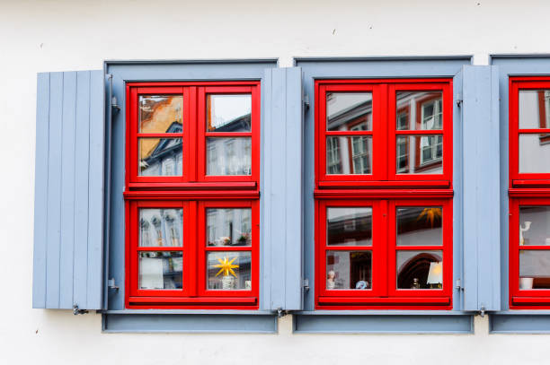 red window on orange wall background house fasade architecture detail, scandinavia