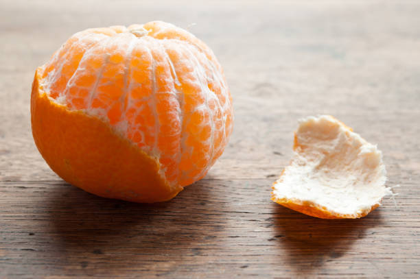 istock peeled  tangerine on wooden background 841719510