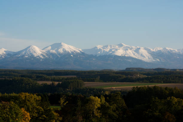 istock Fall hillside in autumn and mountain ranges of first crown snow 841726736