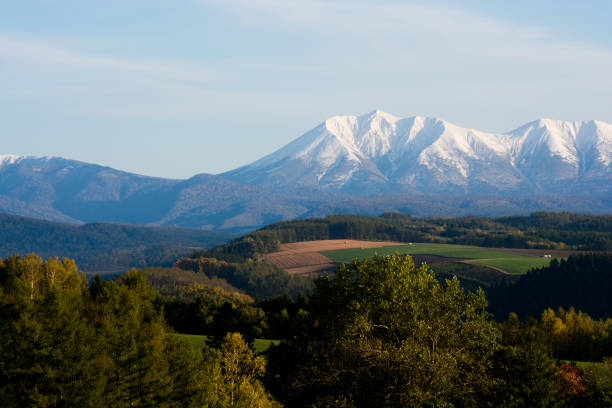 istock Fall hillside in autumn and mountain ranges of first crown snow 841726808
