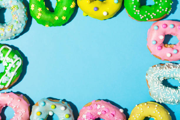 Colorful glazed donuts on a bright background