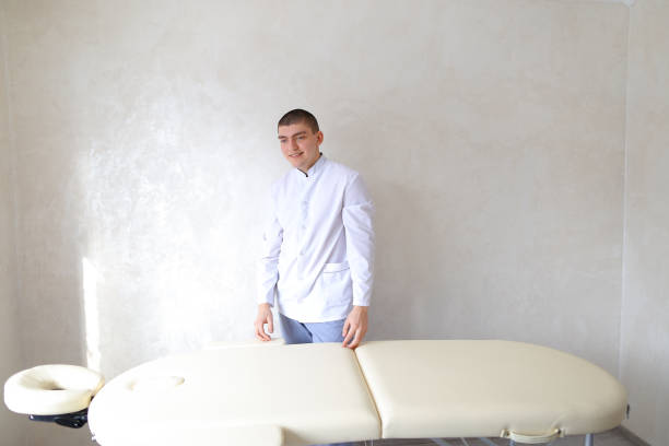istock Educated male masseur looks at camera with friendly smile on fac 841751836