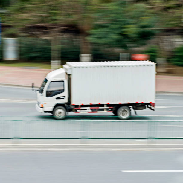 istock White freight truck driving on the road 841755724